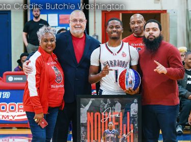 basketball player standing with family